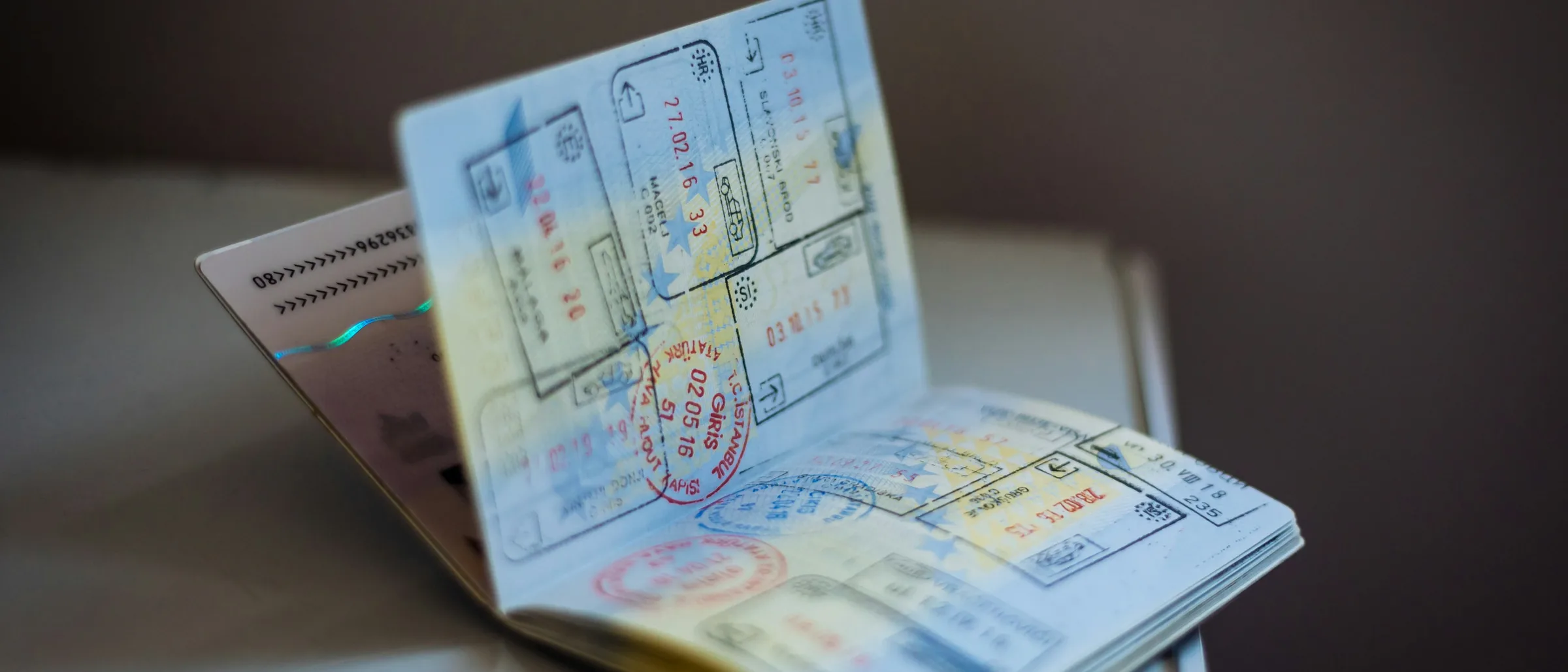 Open passport with visa stamps resting on a table