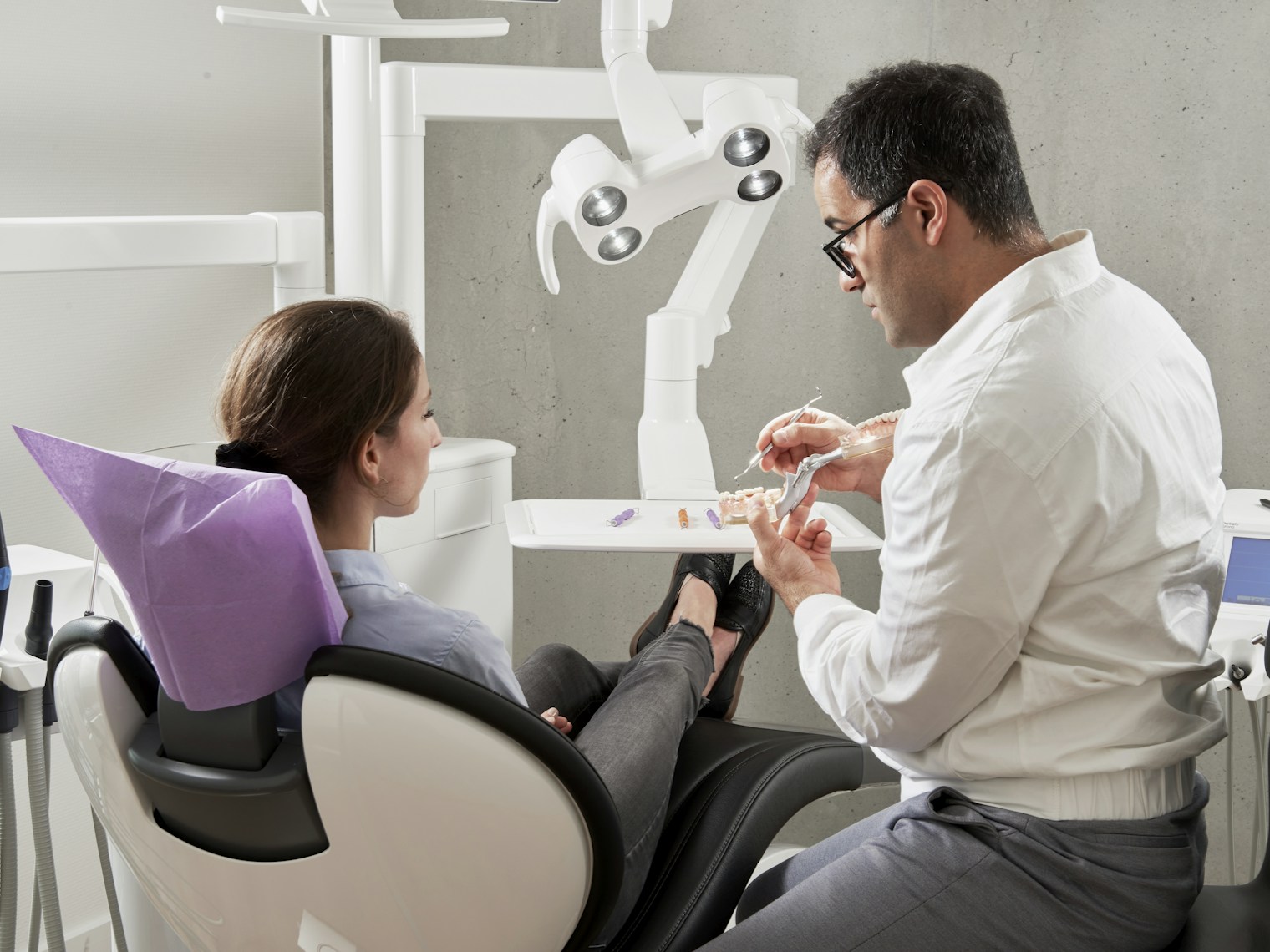 A dentist listening to an adult patient