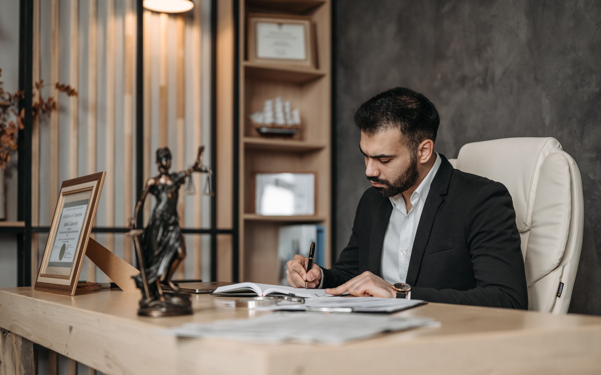 Professional reviewing paperwork at an office desk