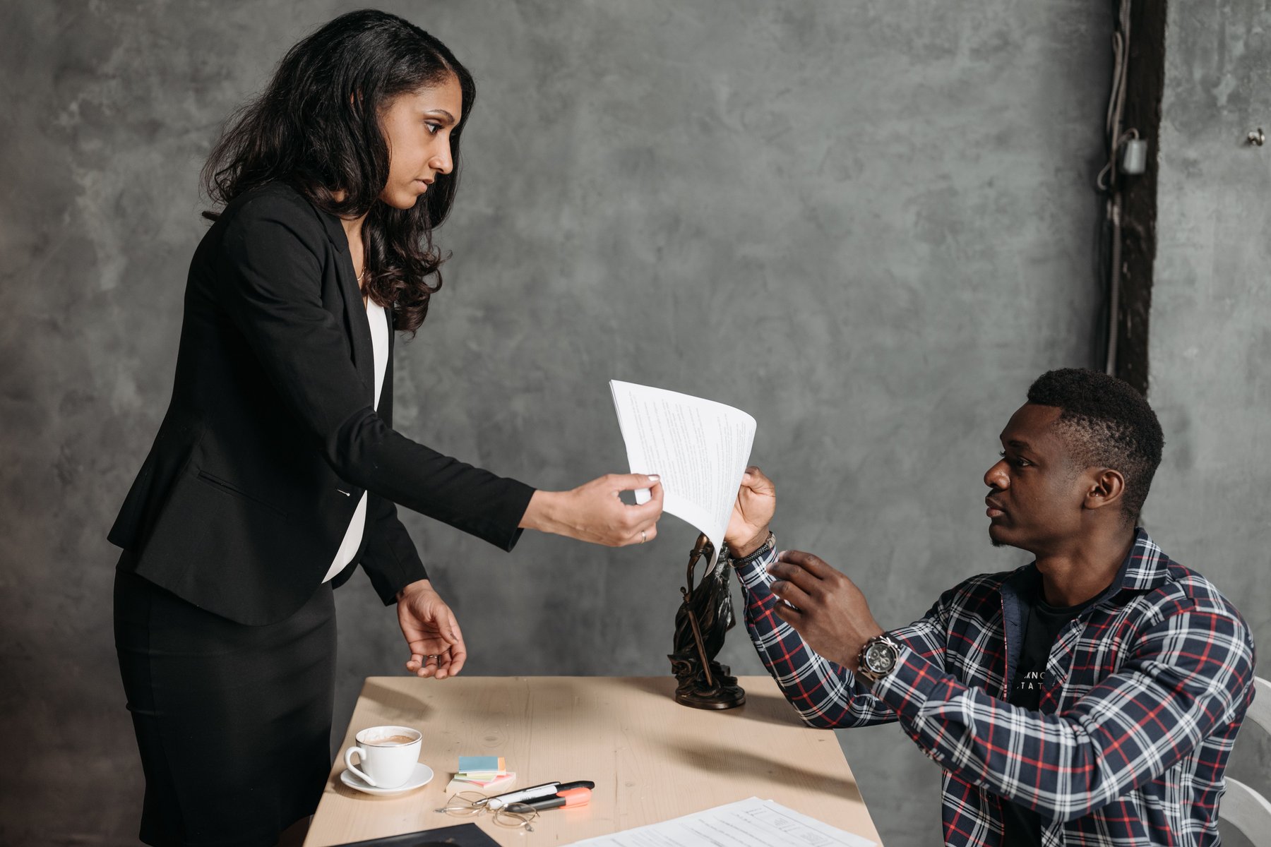 Two people thoughtfully reviewing paperwork together