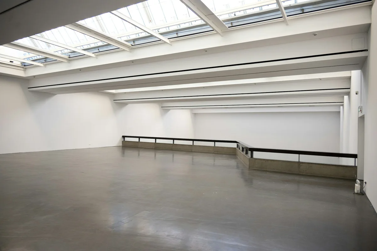 Caldey Yard: a white north-lit studio under a run of roof lights