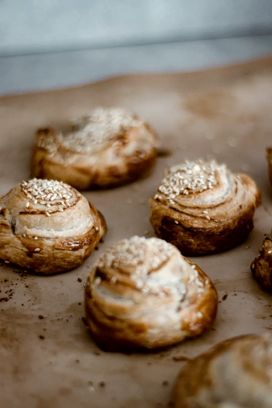 Cardamom buns with pearl sugar cooling on baking paper