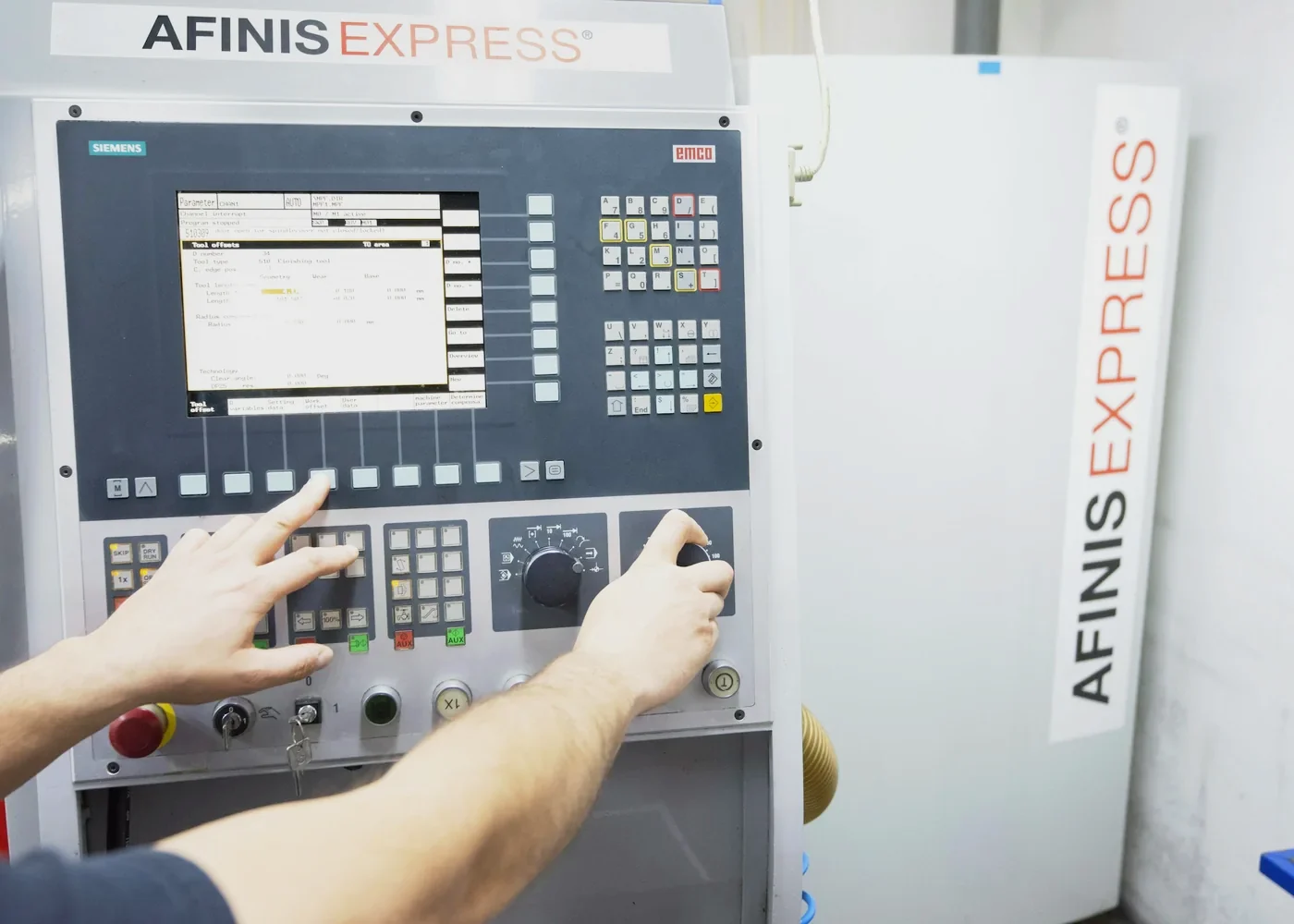 Machinist entering a program on a CNC control panel