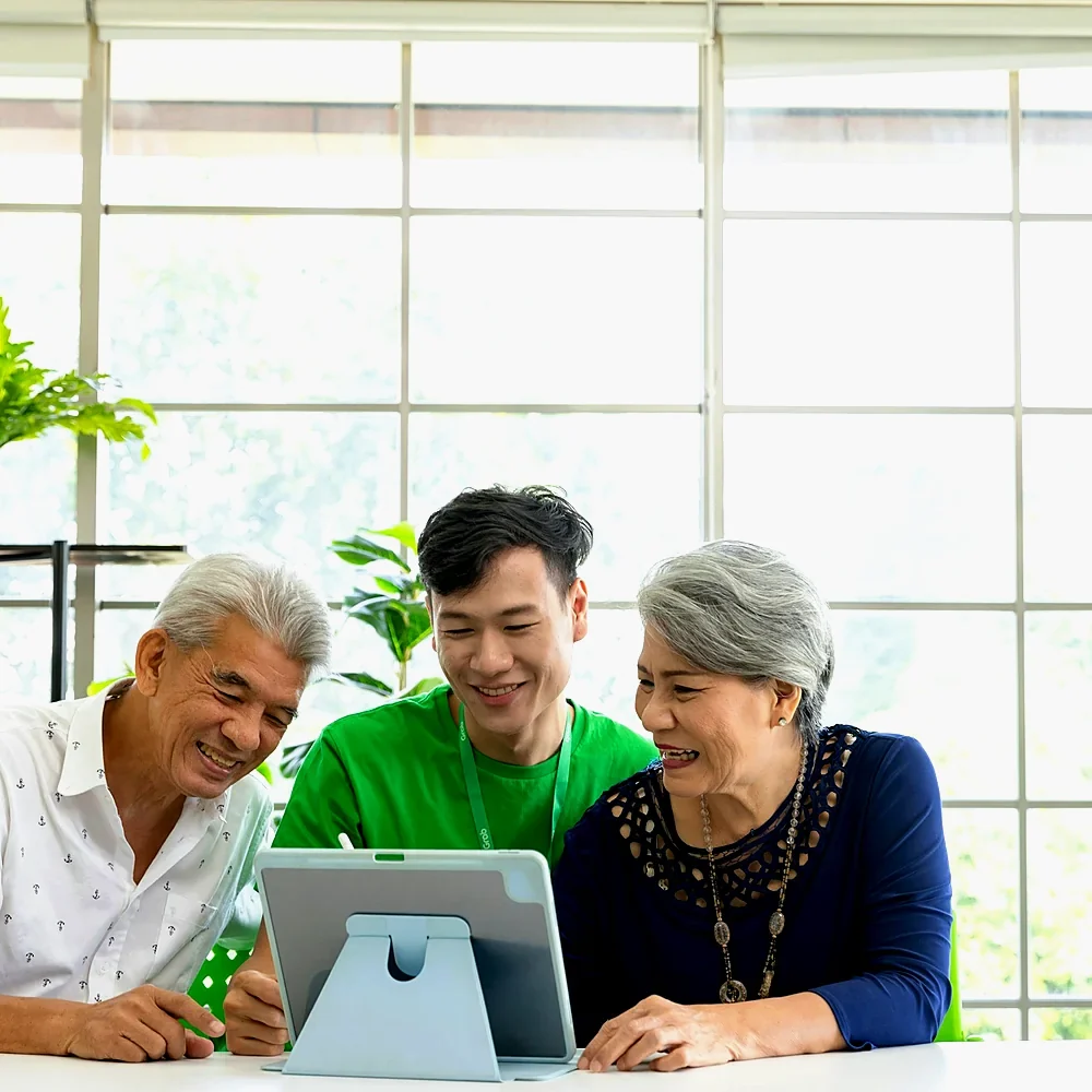 Three generations of one family reviewing their plan together on a tablet