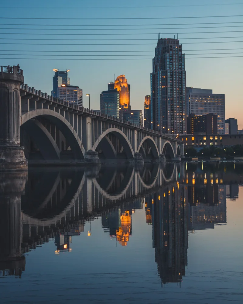 The Third Avenue Bridge and the Minneapolis skyline reflected in the Mississippi at dusk