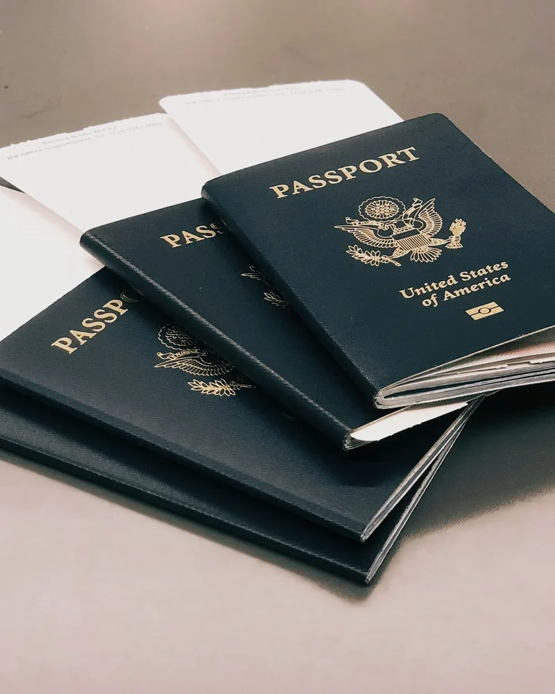 A stack of new United States passports on a desk