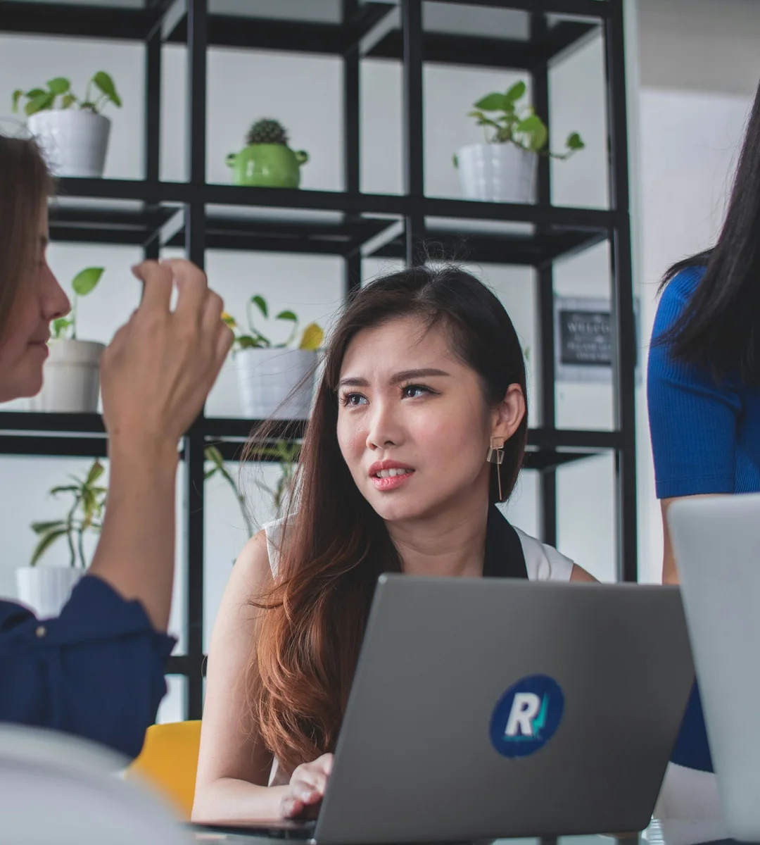 A client and an adviser reviewing a case on a laptop together