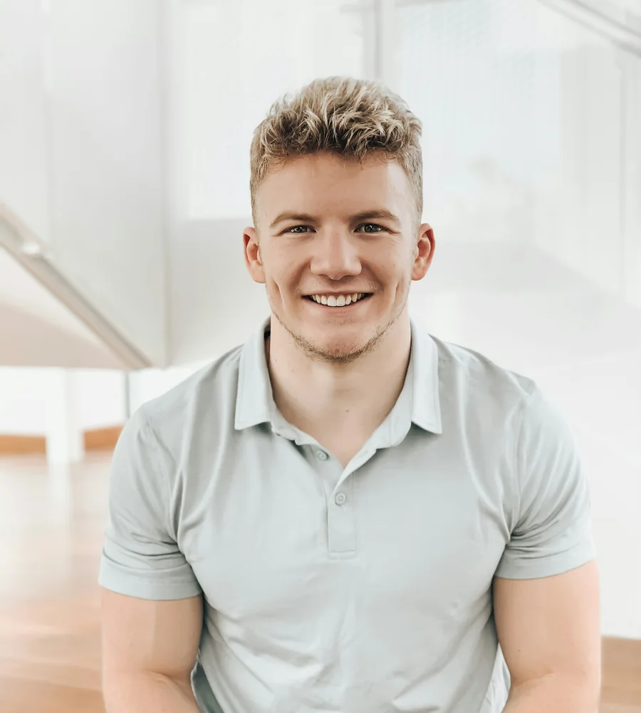 Jake Morrow, physiotherapist, smiling in a bright clinic